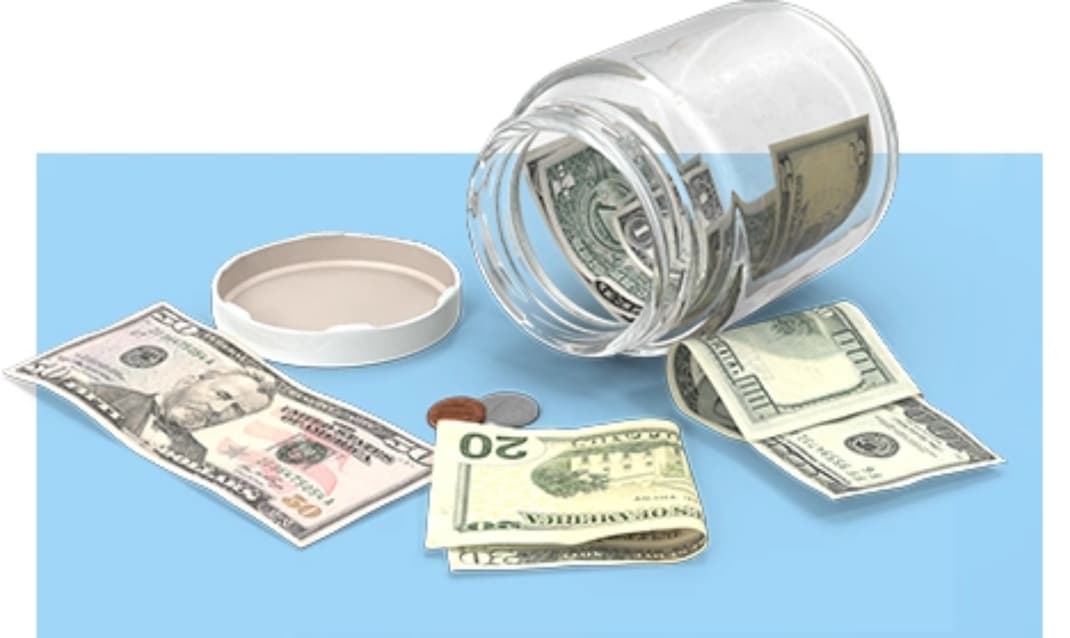 Jar of dollars and coins tipped over on a table